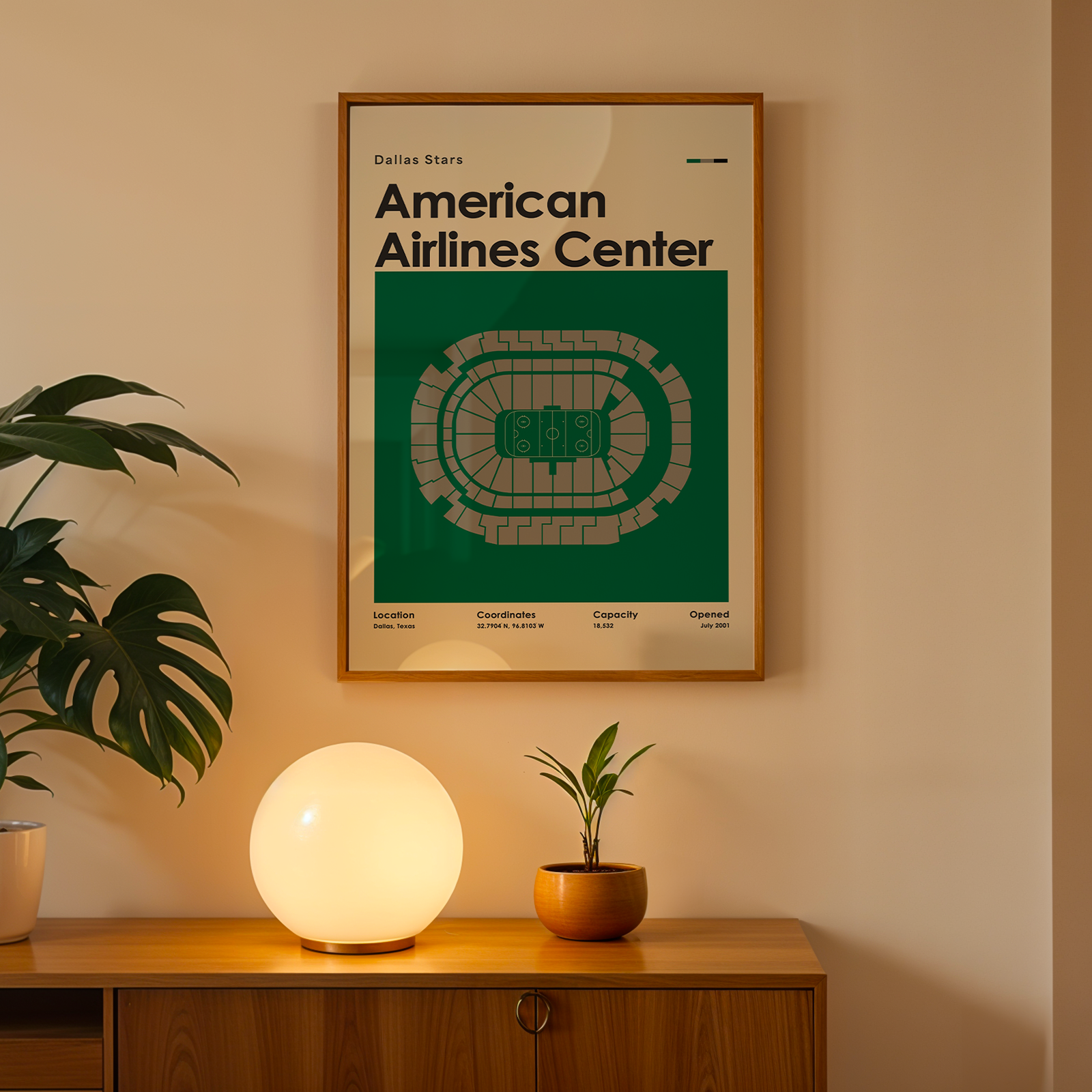 Framed poster of American Airlines Center on a wall above a wooden cabinet with decorative items.