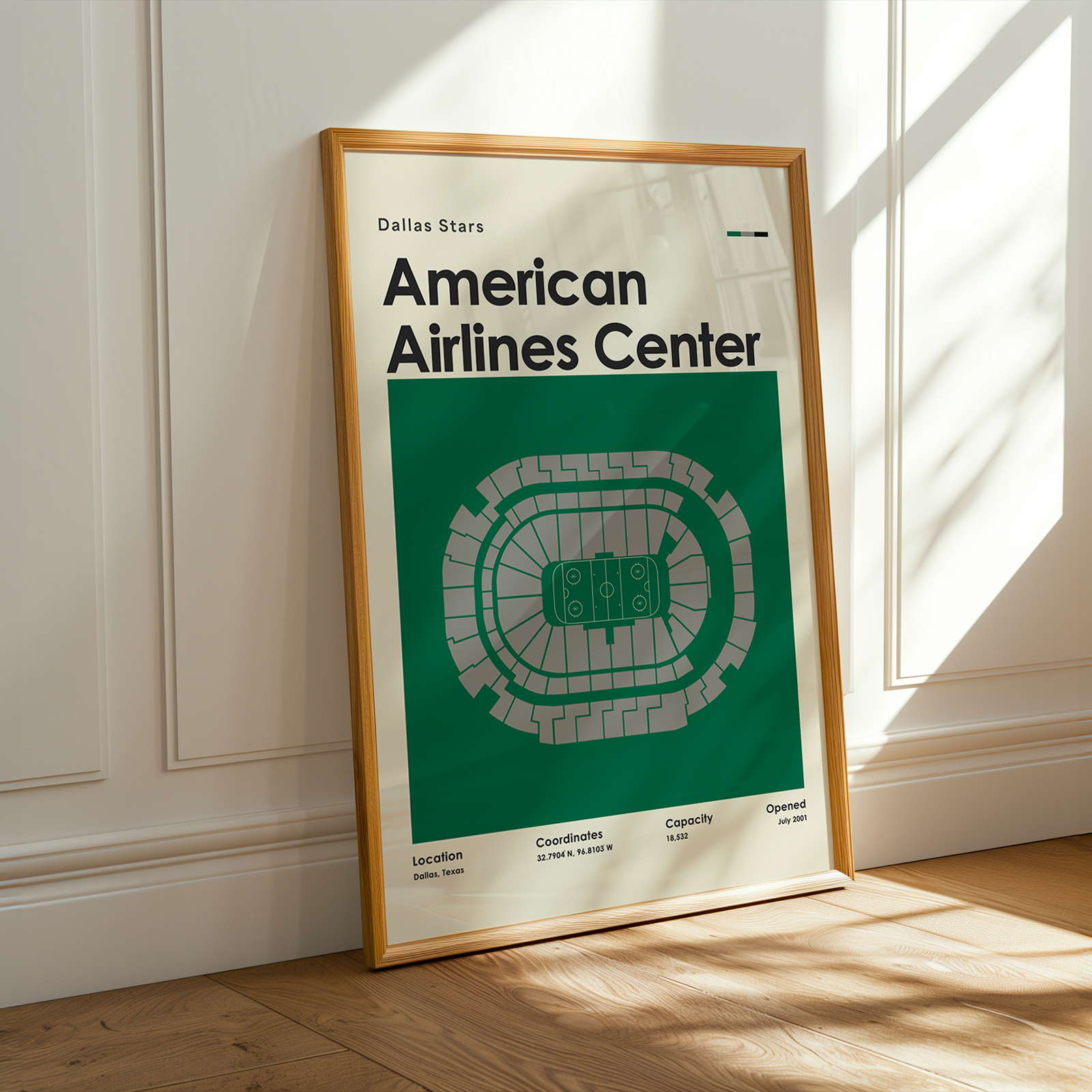 Framed poster of American Airlines Center on a wooden floor with sunlight streaming through a window.