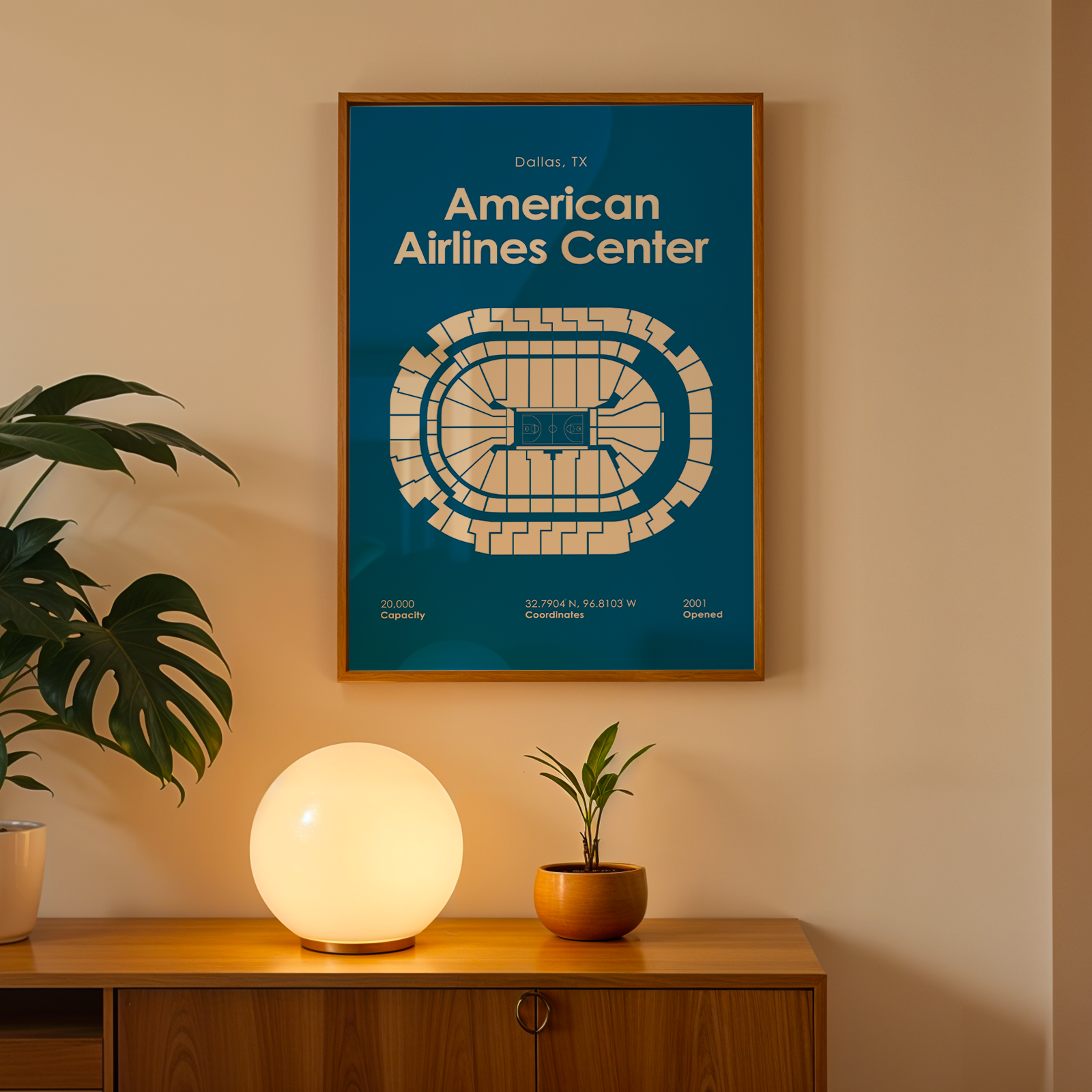 Framed map of American Airlines Center on a wall above a wooden cabinet with decorative items.