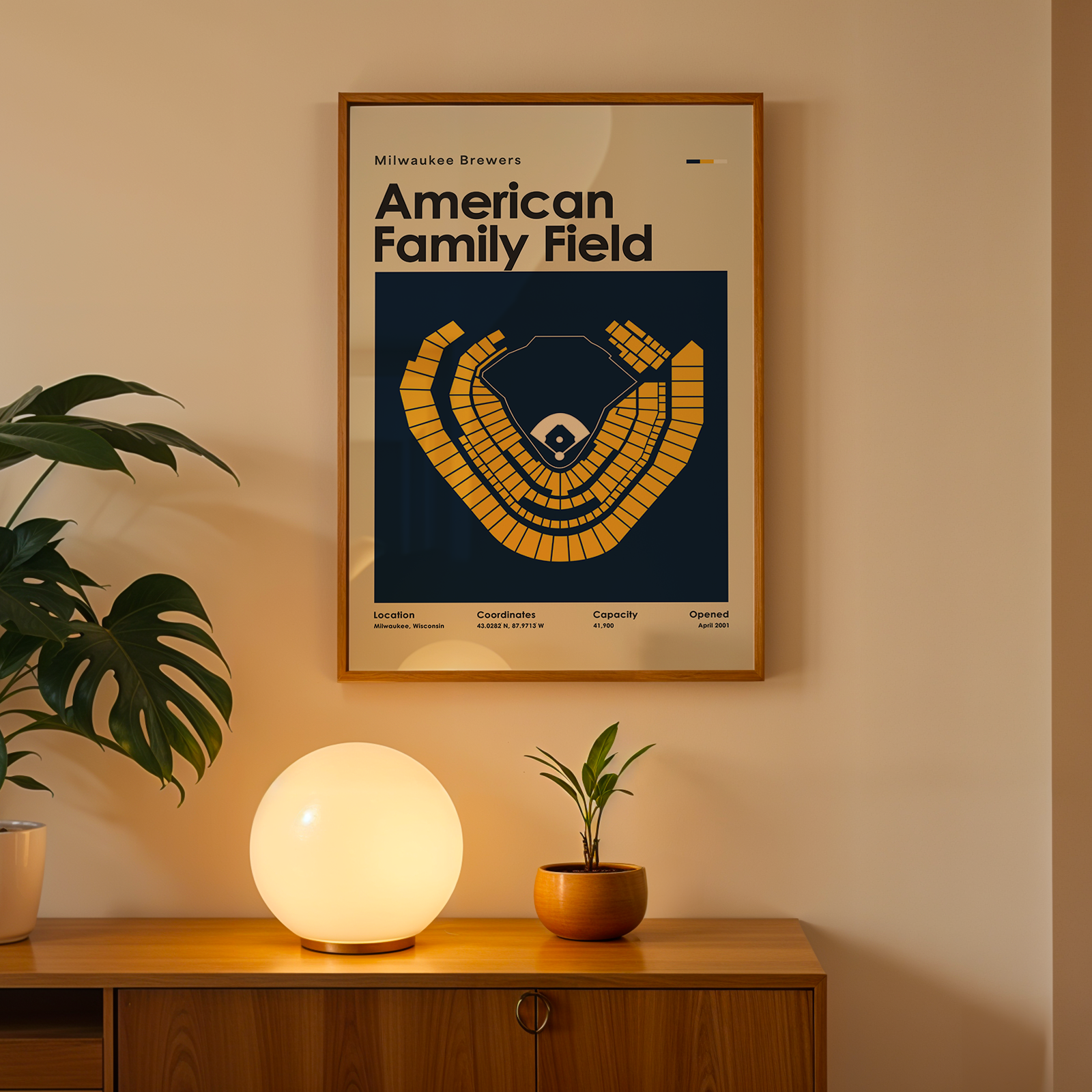 Framed poster titled 'American Family Field' on a wall above a wooden cabinet with decorative items.