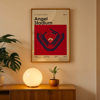 Framed poster of Angel Stadium on a wall above a wooden cabinet with decorative items.