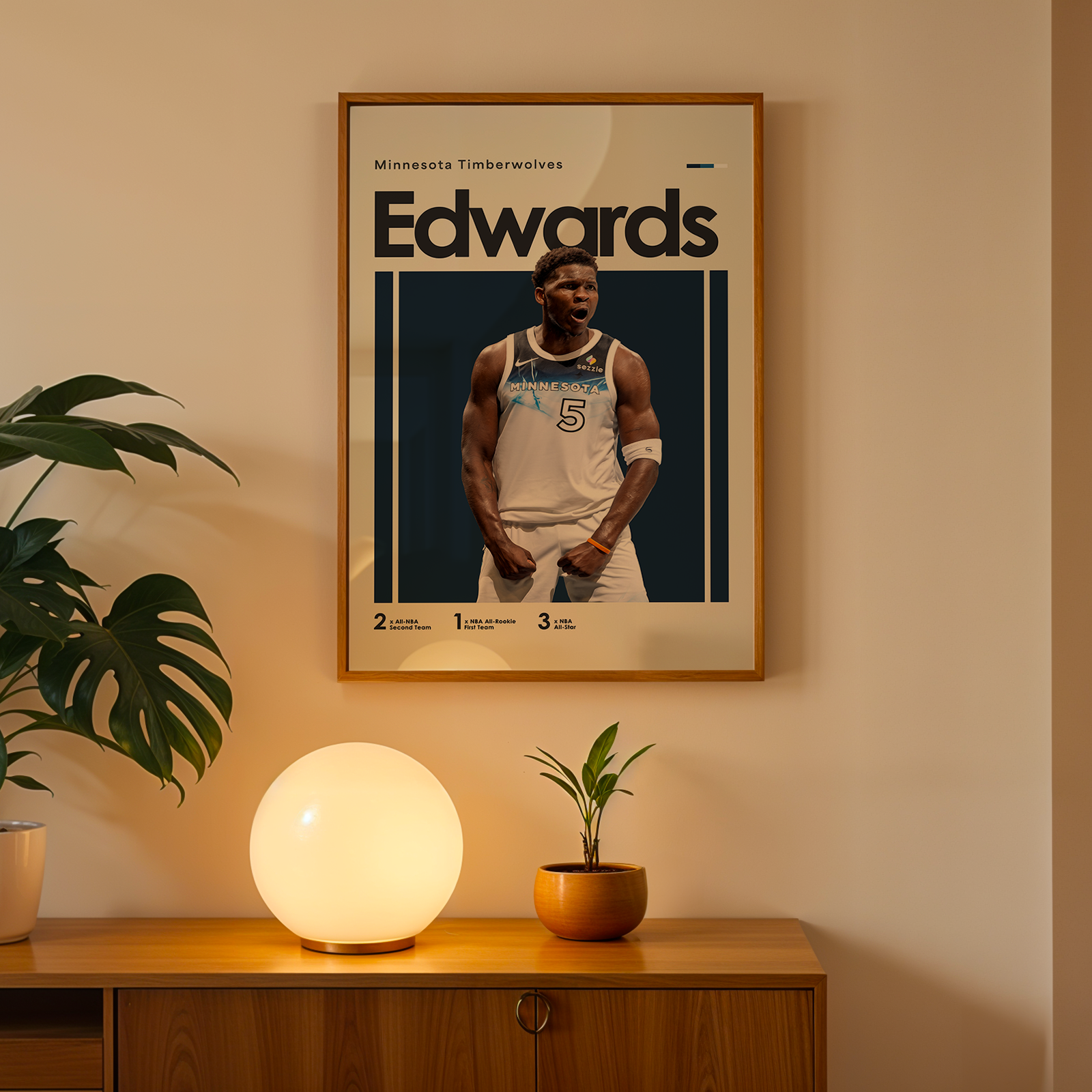 Framed poster of a basketball player named Edwards on a wall above a wooden cabinet with decorative items.