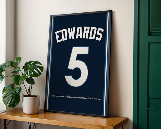Framed sports jersey with 'EDWARDS' and number '5' on a wooden shelf.