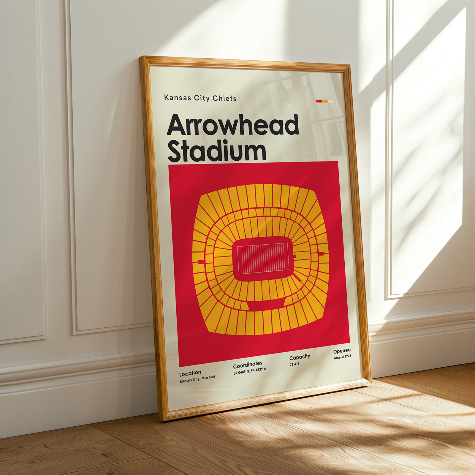 Framed poster of Arrowhead Stadium with Kansas City Chiefs branding on a wooden floor.