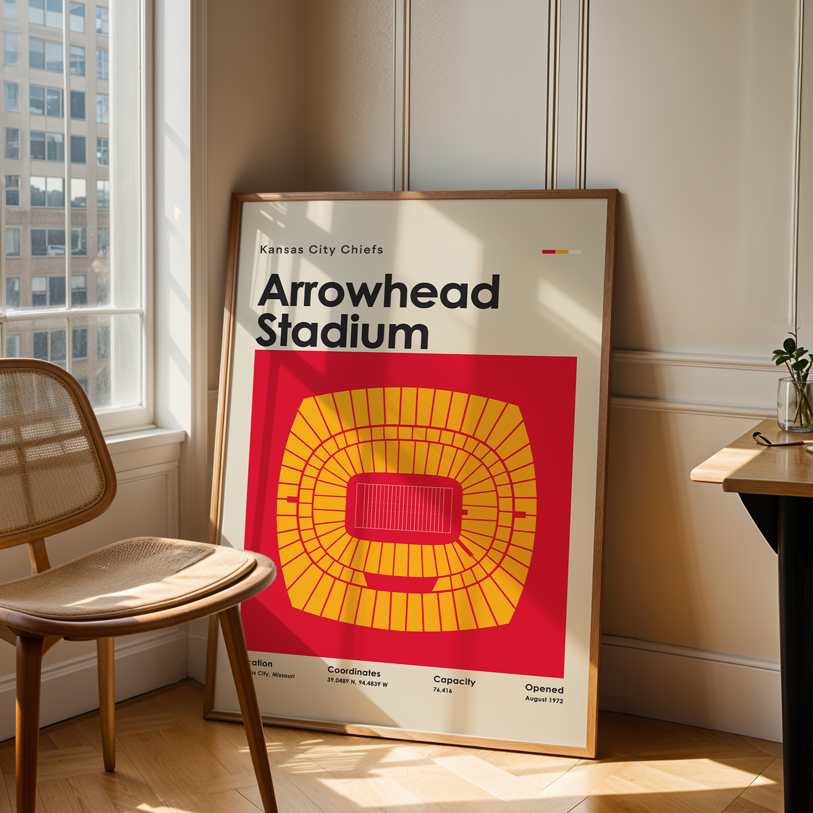 Poster of Arrowhead Stadium in a room with a chair and table.