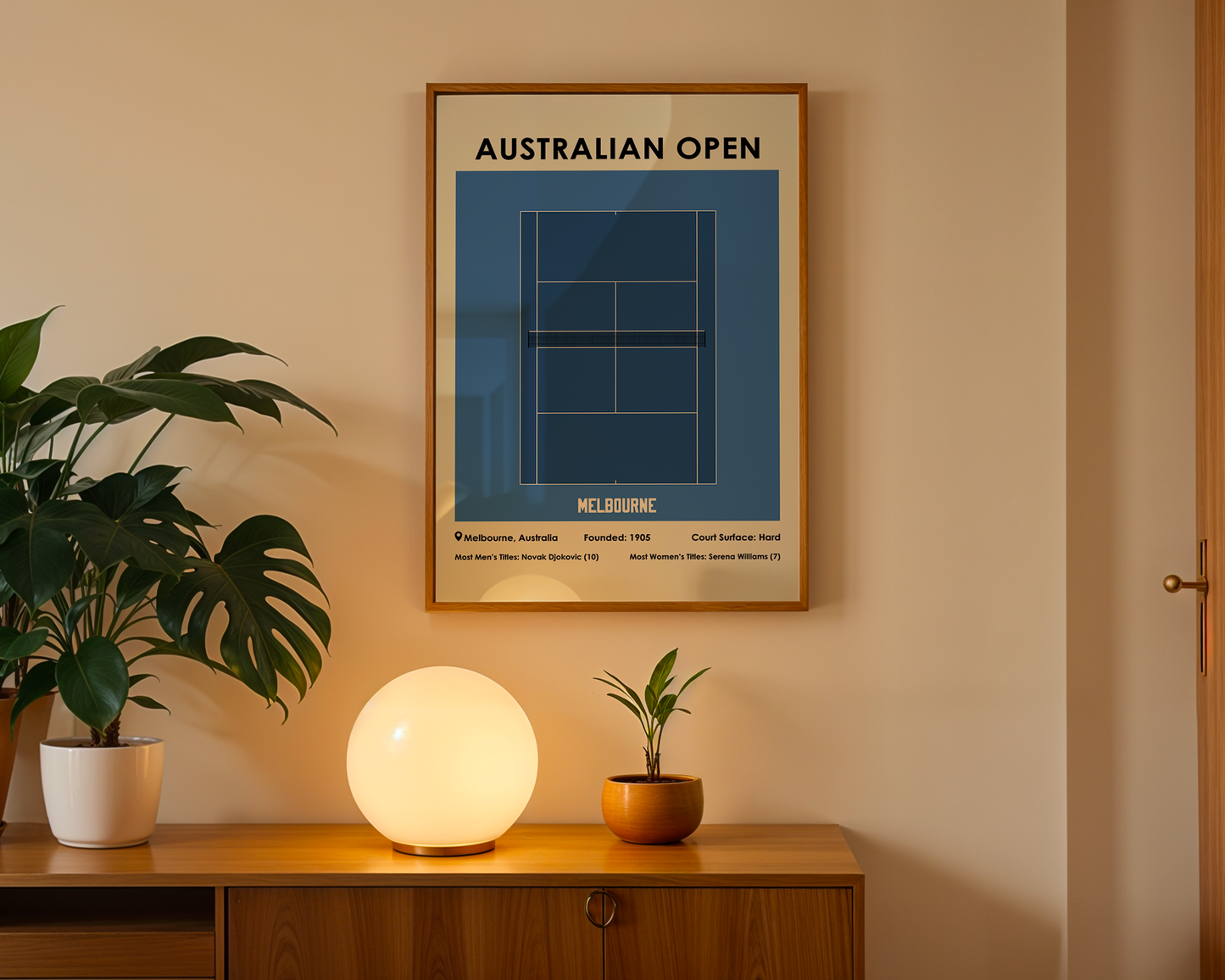 Framed Australian Open poster on a wall above a wooden cabinet with decorative items.