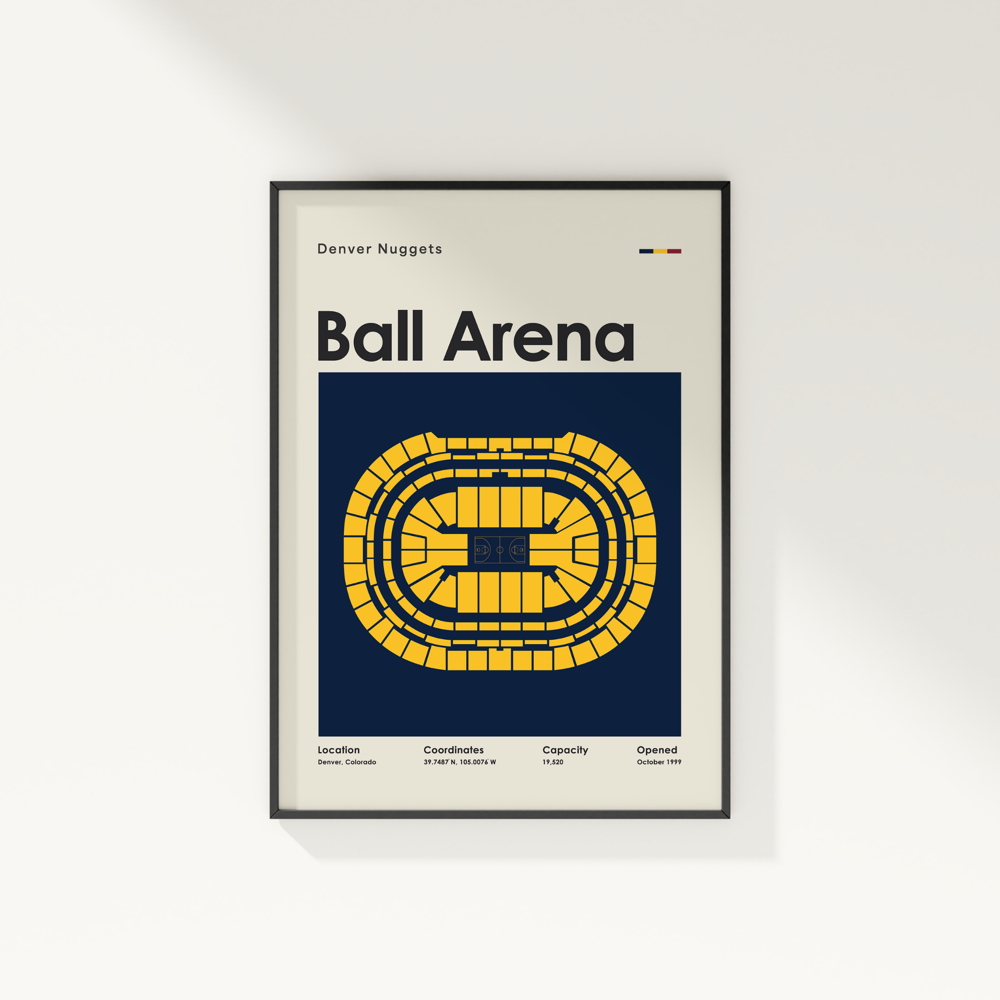 Framed poster of Ball Arena with Denver Nuggets branding on a white wall.