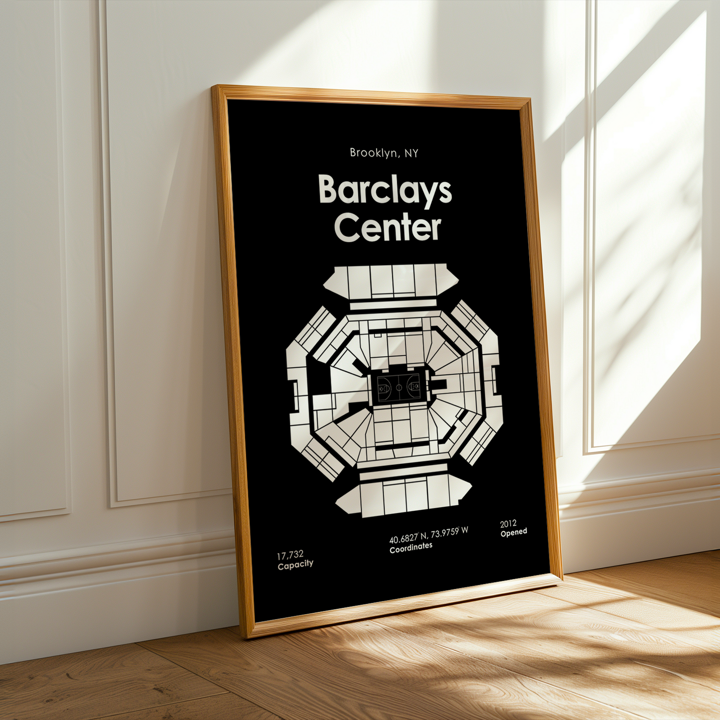 Framed map of Barclays Center on a wall with sunlight casting shadows.