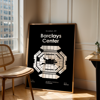 Framed poster of Barclays Center in Brooklyn, NY, leaning against a wall in a room with a chair and table.
