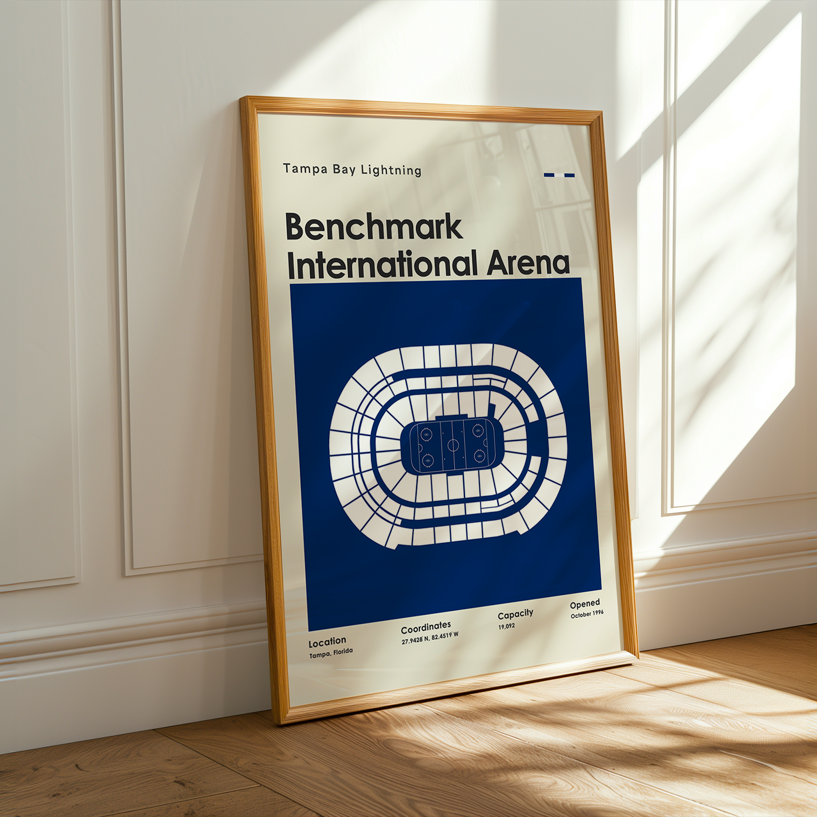 Framed poster of Benchmark International Arena with Tampa Bay Lightning logo on a wooden floor.