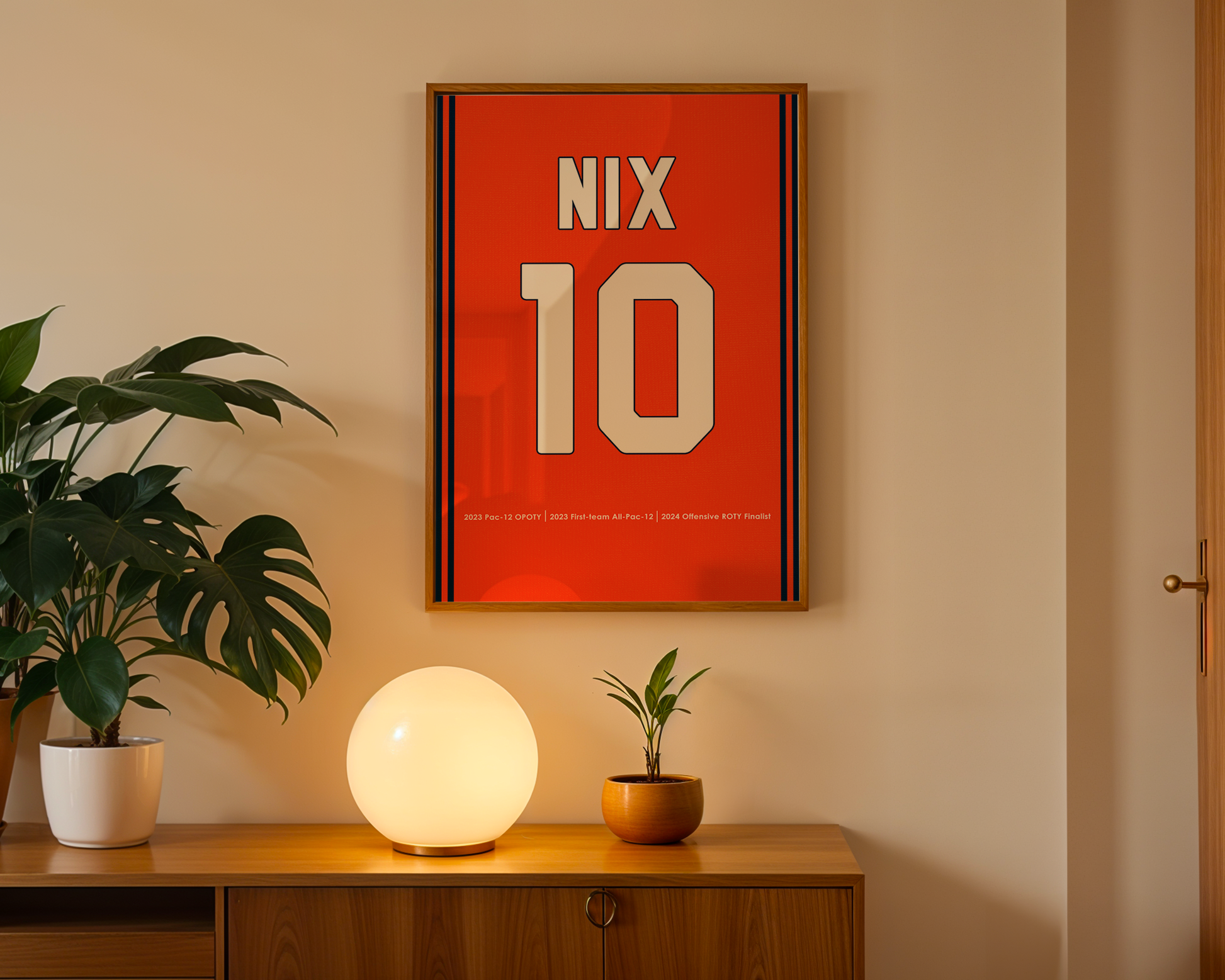 Framed poster with 'NIX 10' on a wall above a wooden cabinet with decorative items.