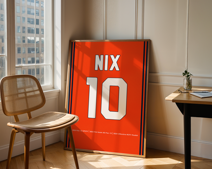 Orange jersey with 'NIX' and number '10' displayed in a room with a chair and table.