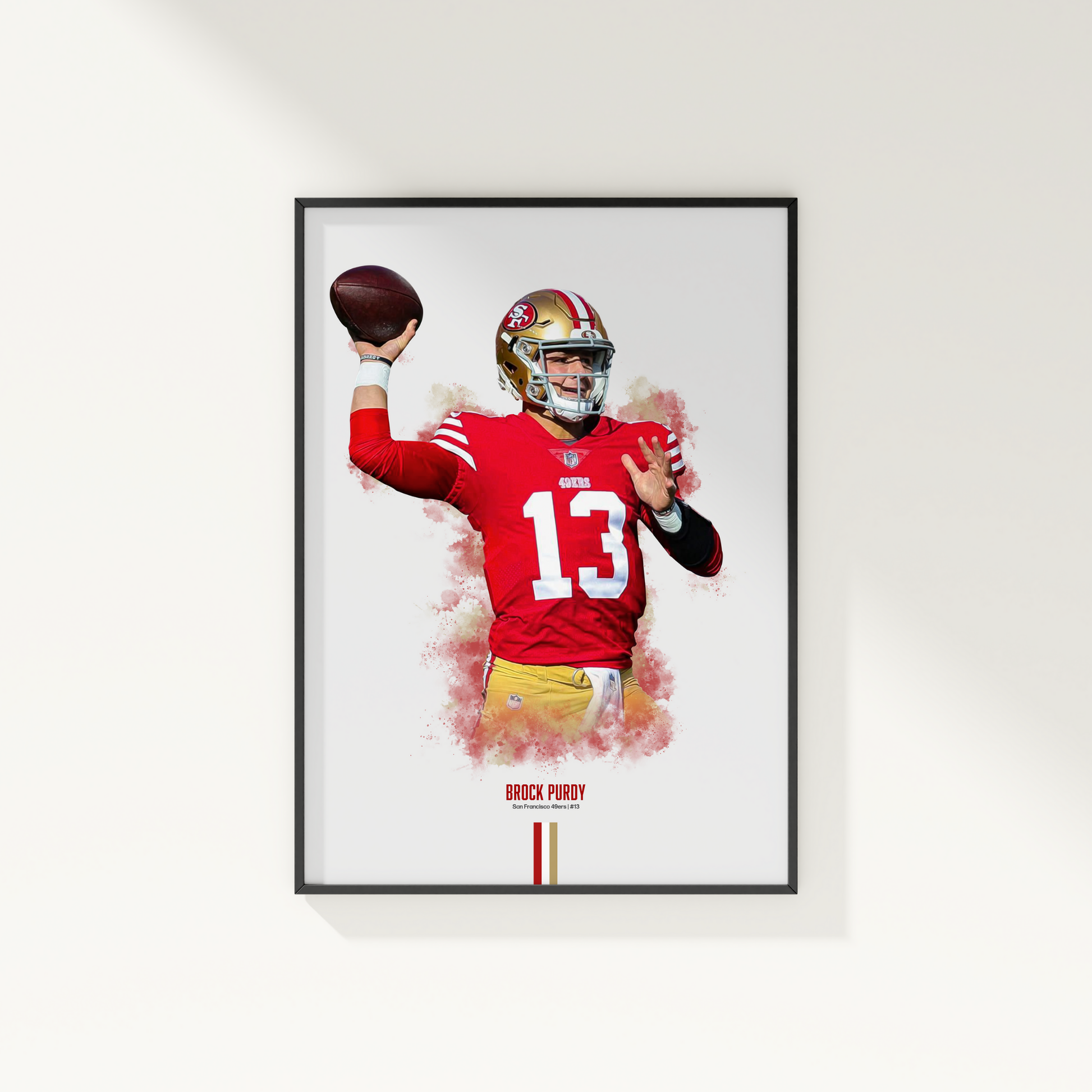 framed poster mockup of football player brock purdy hanging on a white wall