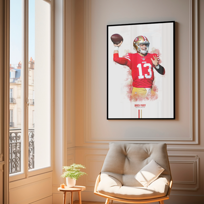 framed poster mockup of football player brock purdy hanging in a living room