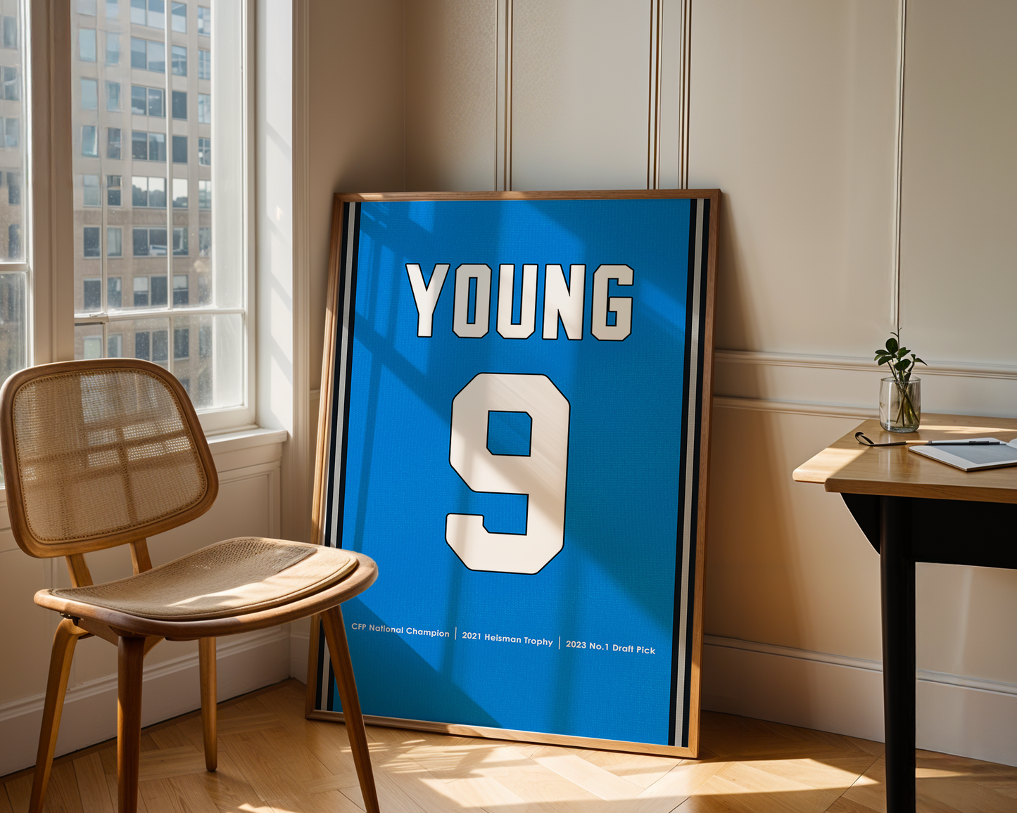 Framed sports jersey with 'YOUNG' and number '9' in a room with a window and chair.