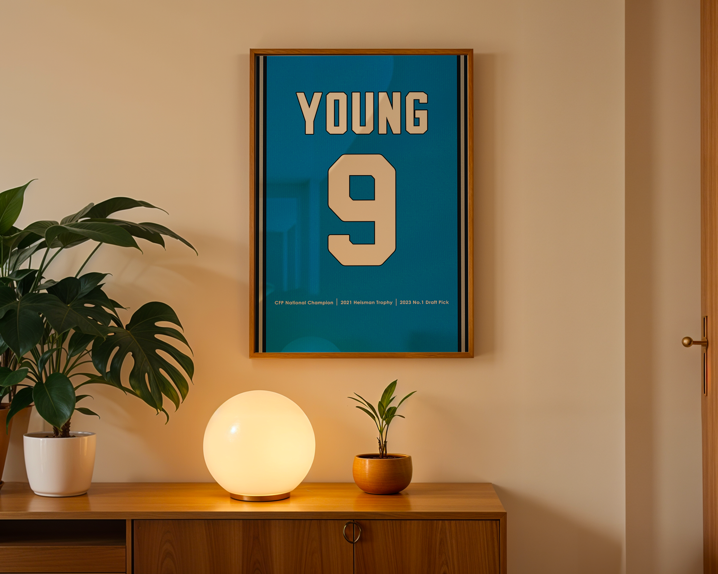 Framed poster with 'YOUNG 9' on a wall above a wooden cabinet with decorative items.