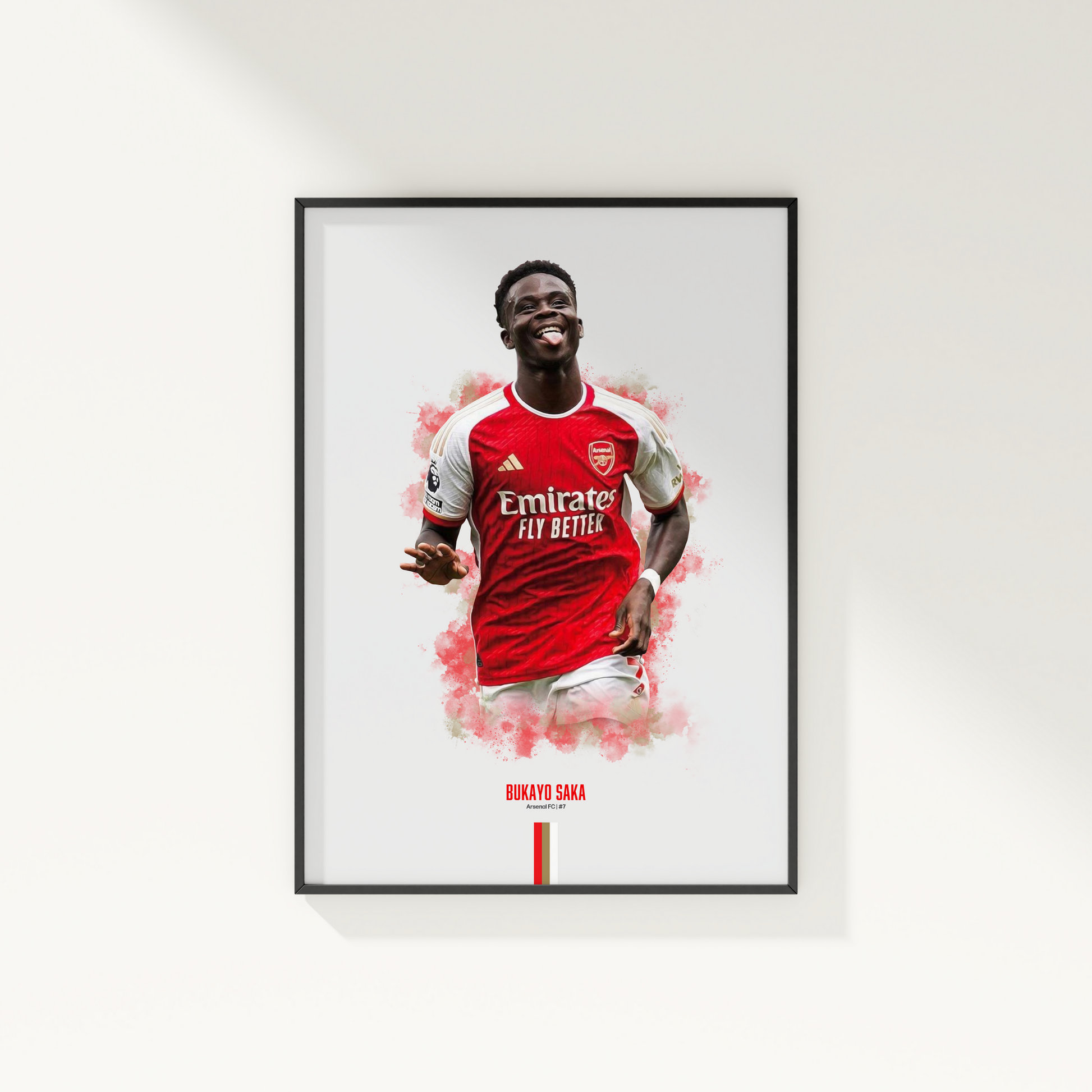 framed poster mockup of soccer player bukayo saka hanging on a white wall