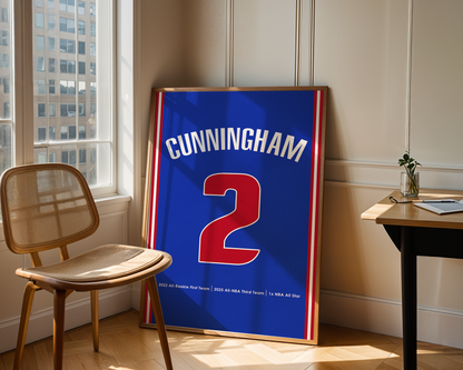 Framed sports jersey with 'Cunningham 2' on a wooden floor near a window.
