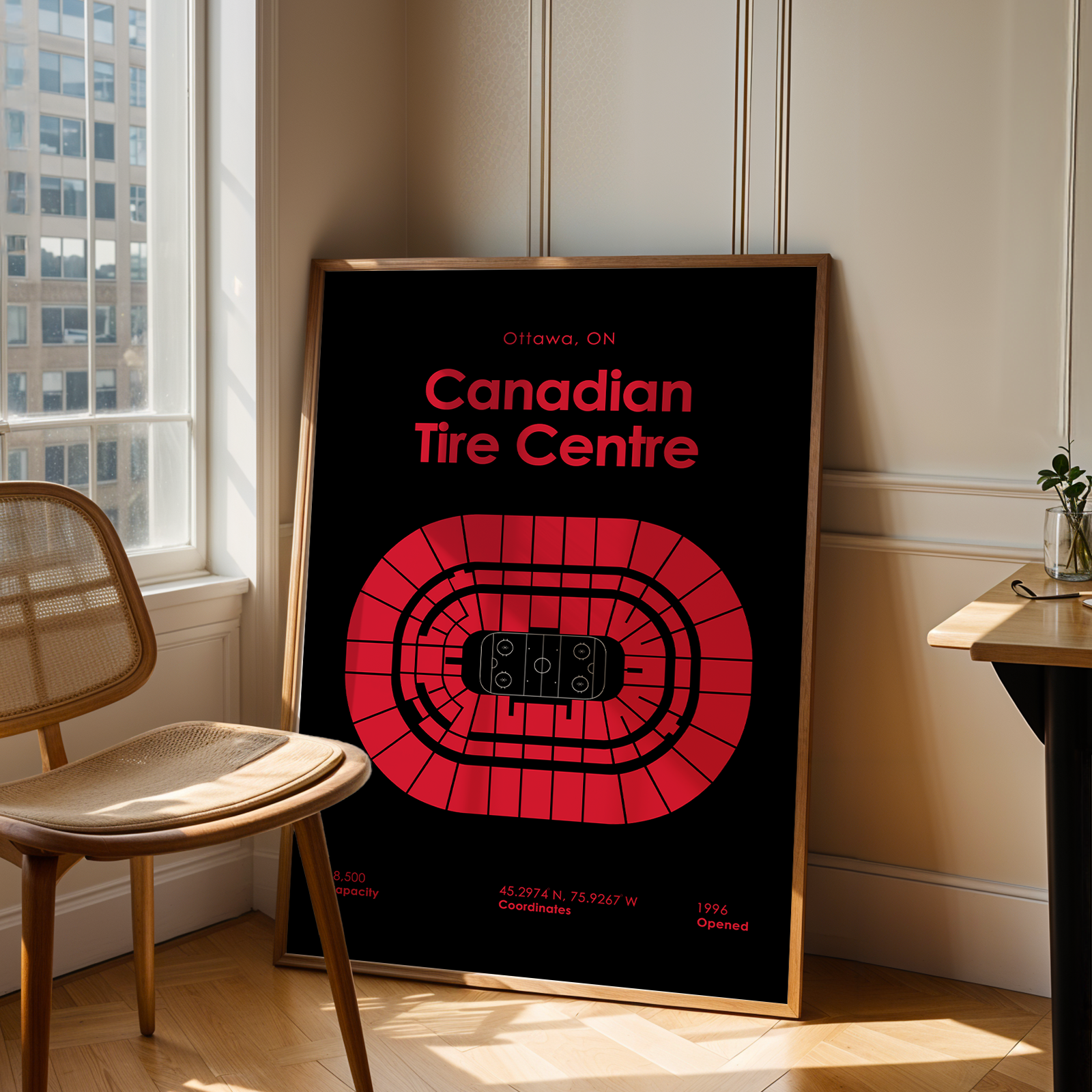 Framed poster of Canadian Tire Centre in a room with a window and chair.