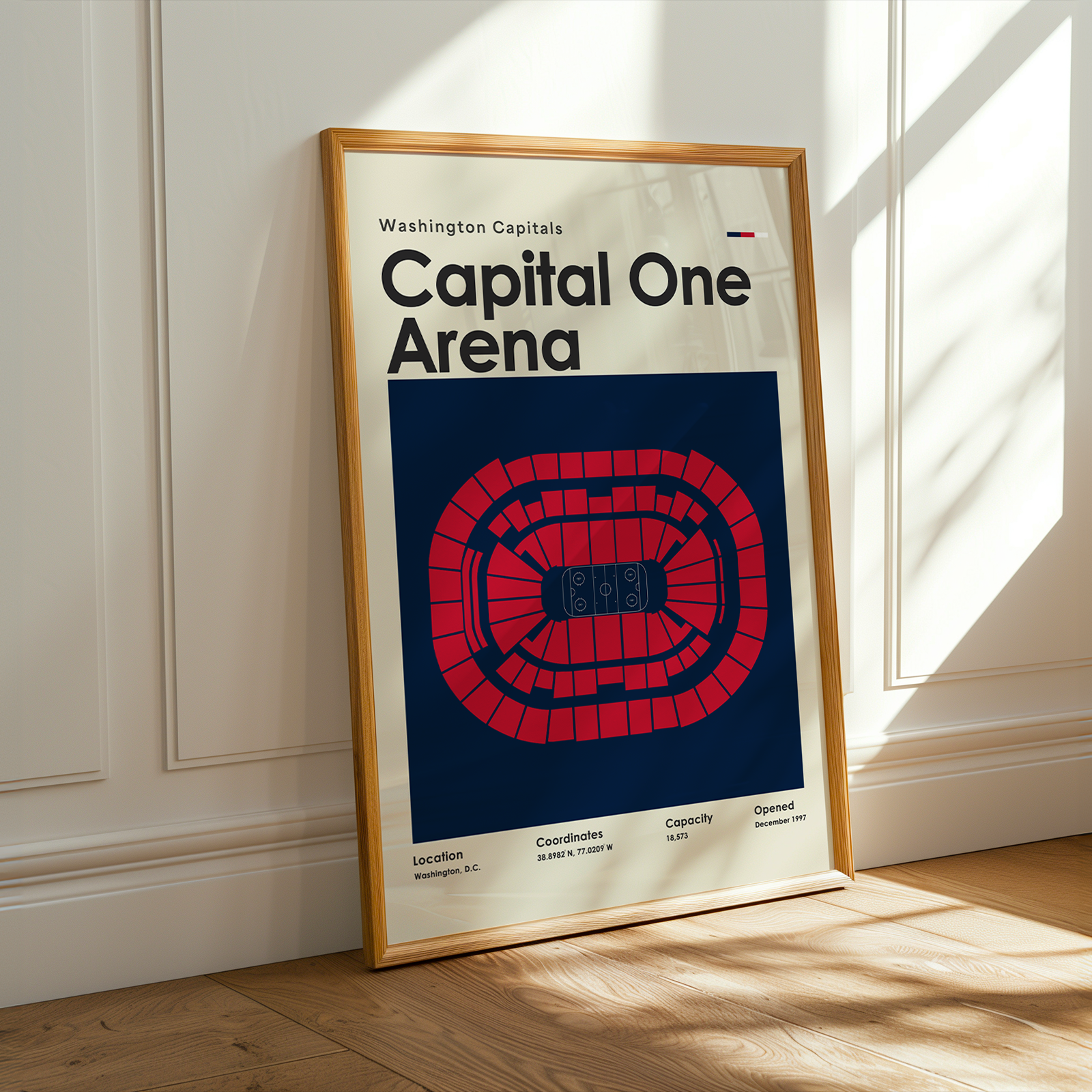 Framed poster of Capital One Arena with a wooden frame on a light-colored wall.