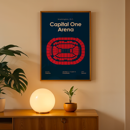 Framed poster of Capital One Arena on a wall above a wooden cabinet with decorative items.