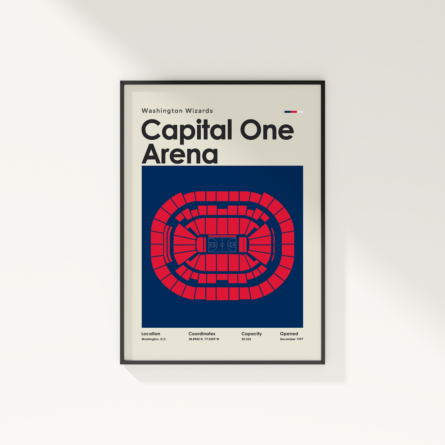 Framed poster of Capital One Arena with red and blue design on a white wall.
