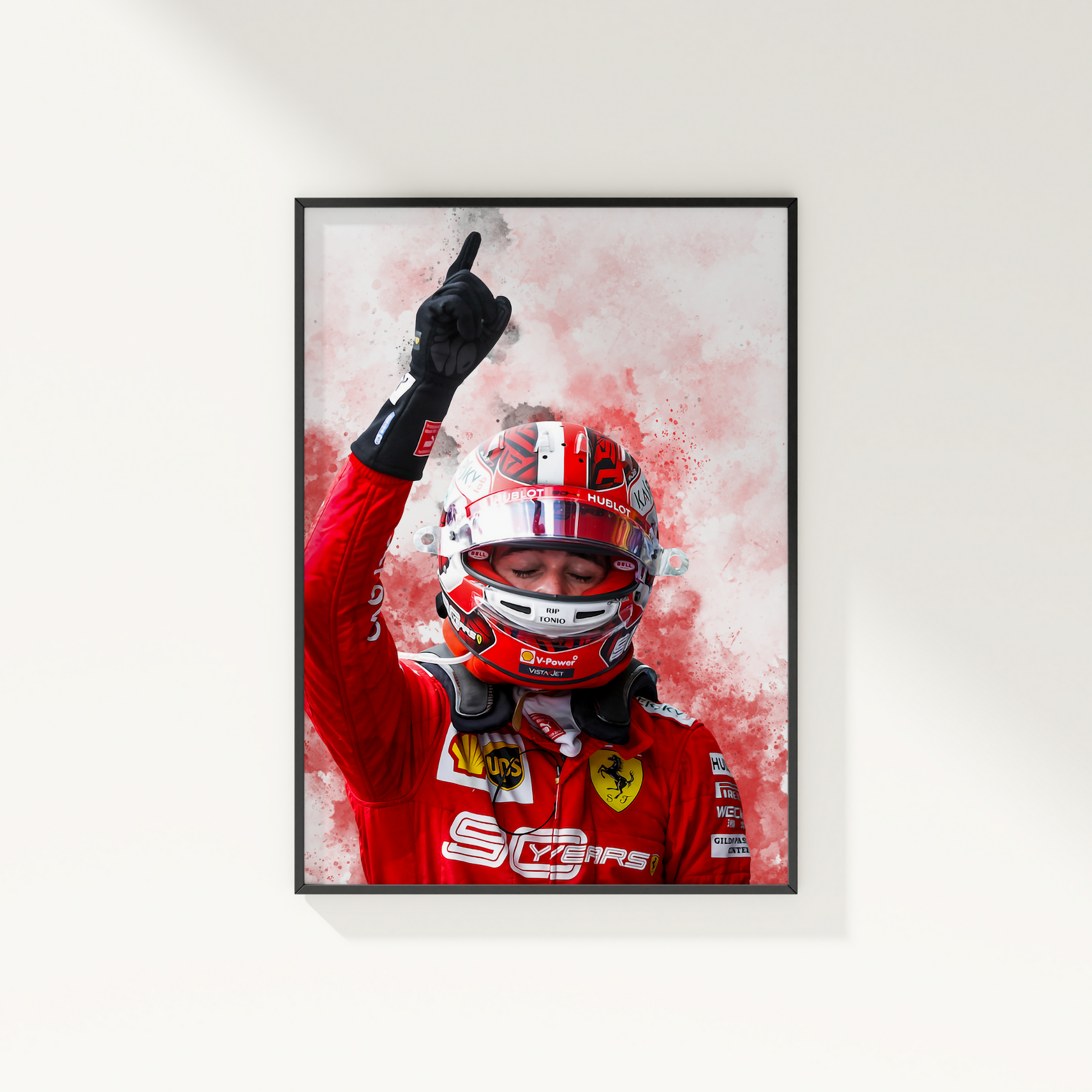 framed poster mockup hanging on a white wall. poster of formula 1 driver charles leclerc celebrating for ferrari.