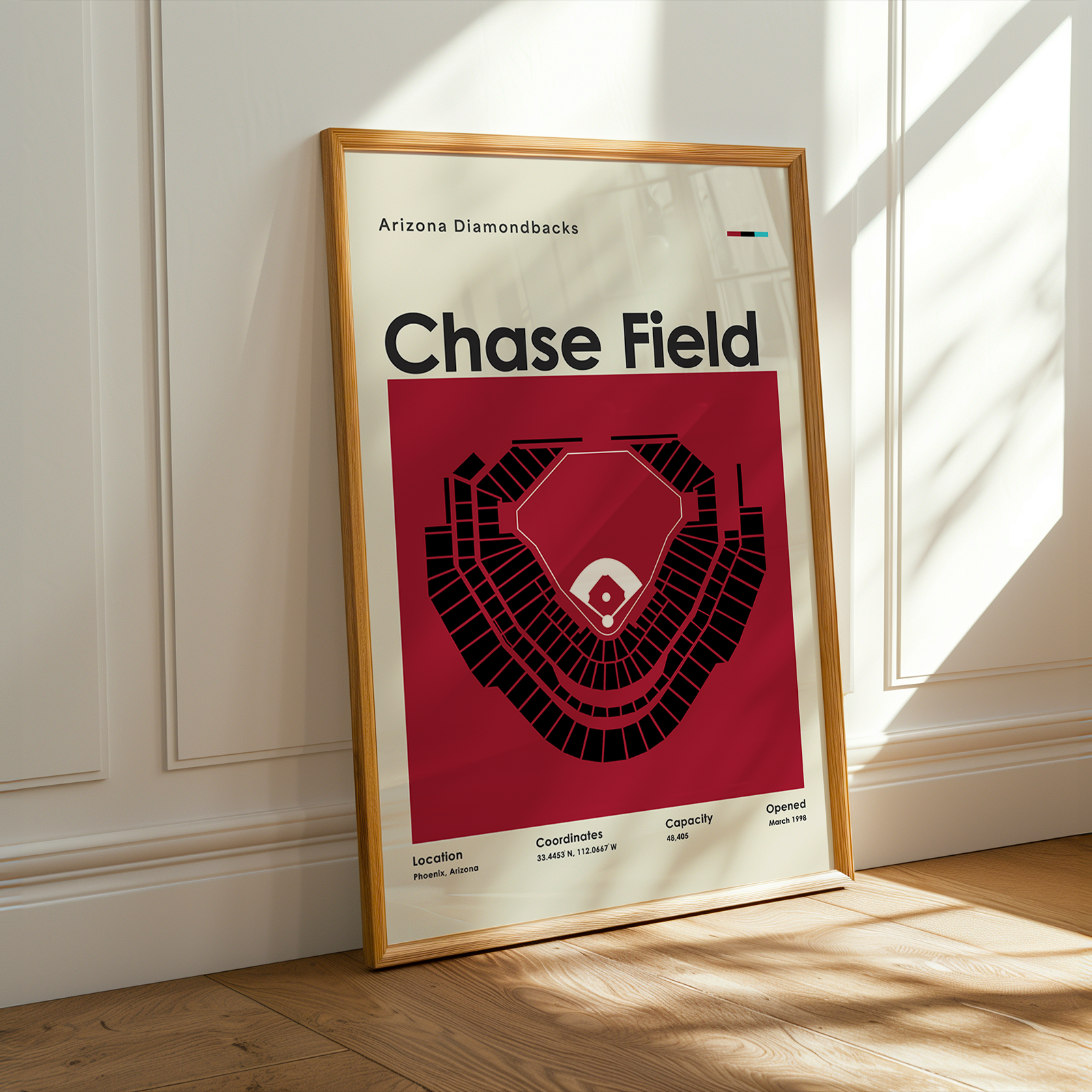 Framed poster of Chase Field in a room with sunlight streaming through a window.