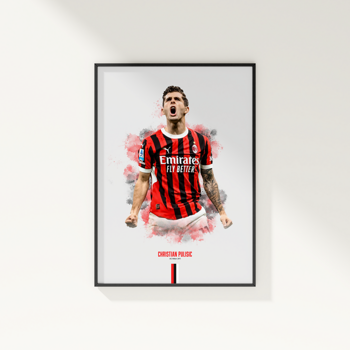 Framed poster print of soccer player Christian Pulisic, wearing an AC Milan jersey, on a white wall.