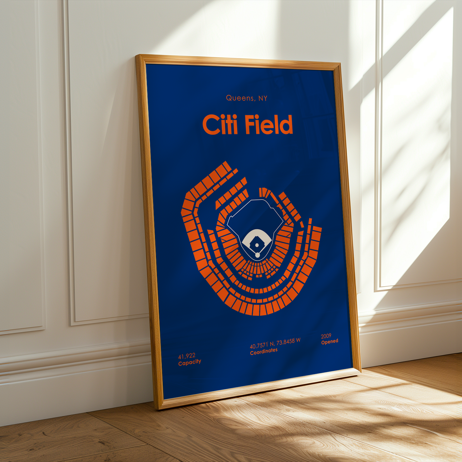 Framed poster of Citi Field design on a wall with sunlight casting shadows.