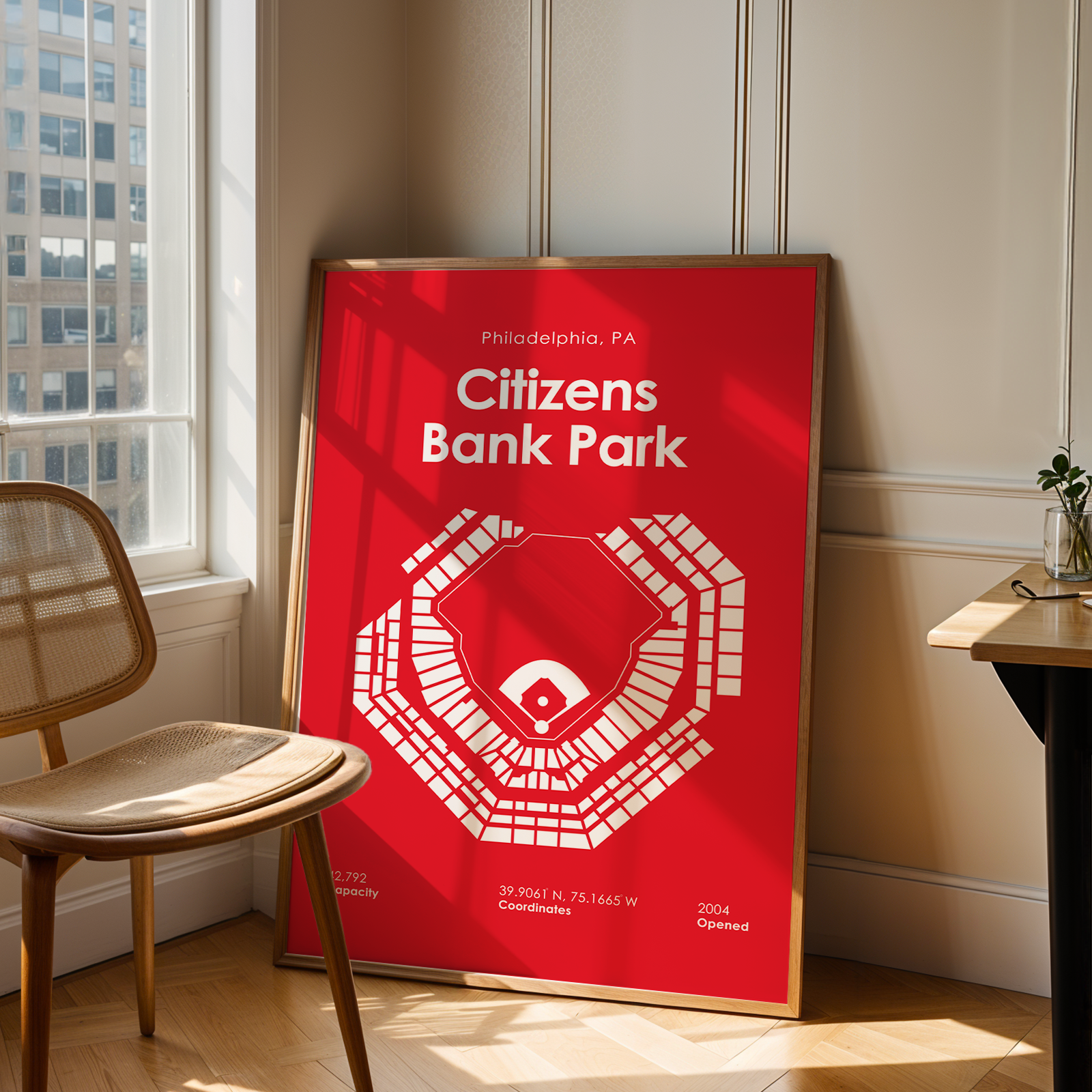 Red poster with 'Citizens Bank Park' design in a room with a chair and window.