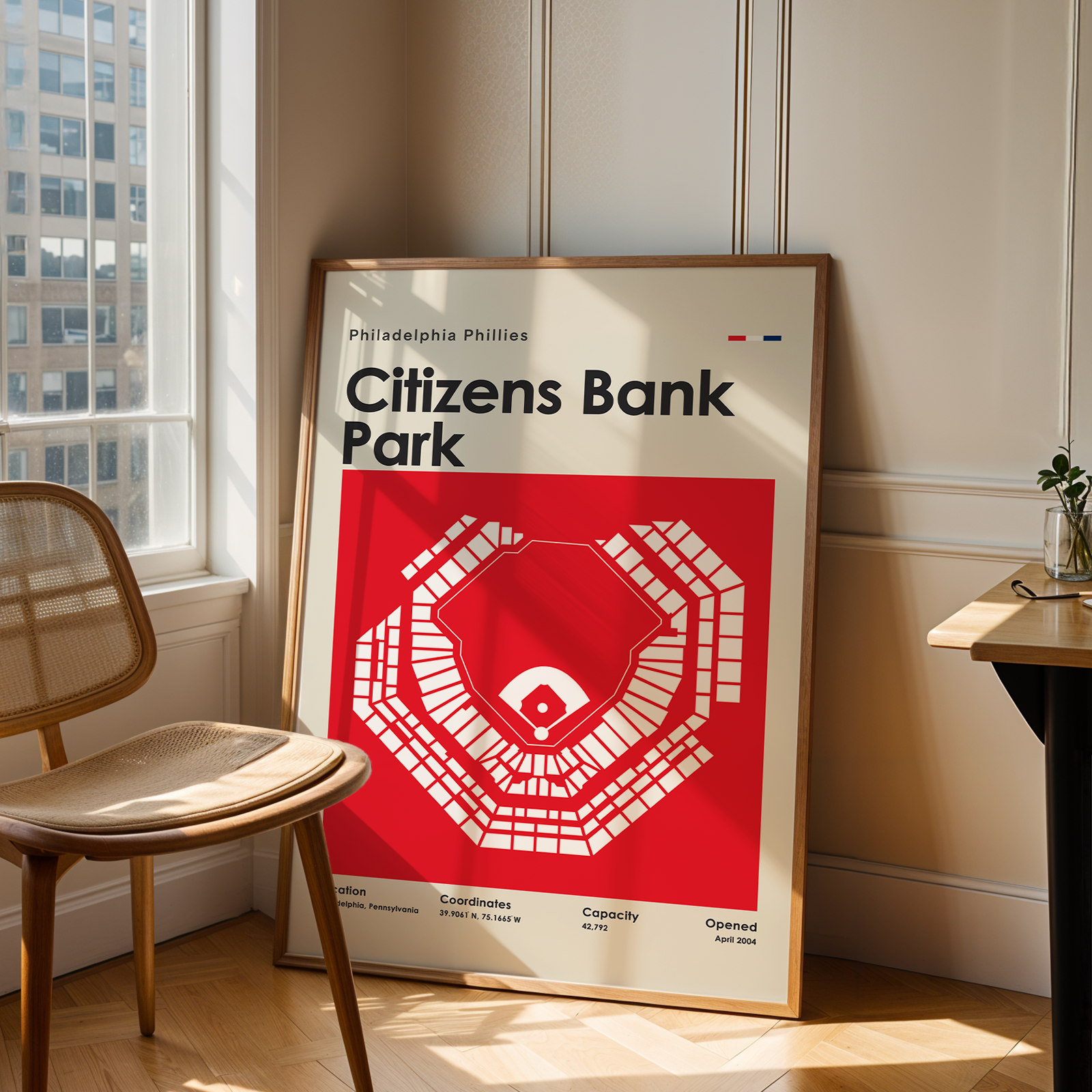 Poster of Citizens Bank Park in a room with a chair and table.