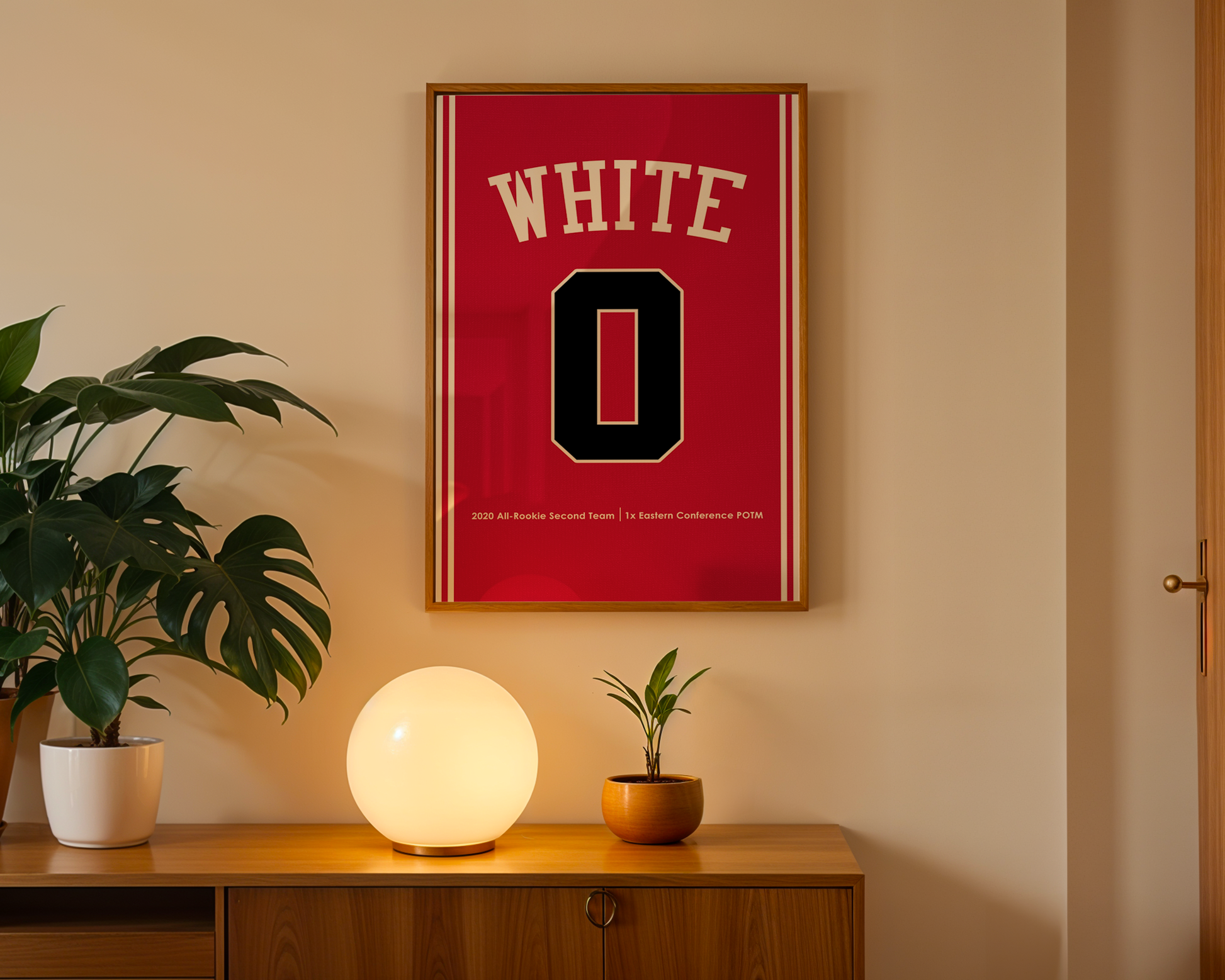 Framed red jersey with 'WHITE' and number '0' on a wall above a wooden cabinet with decorative items.