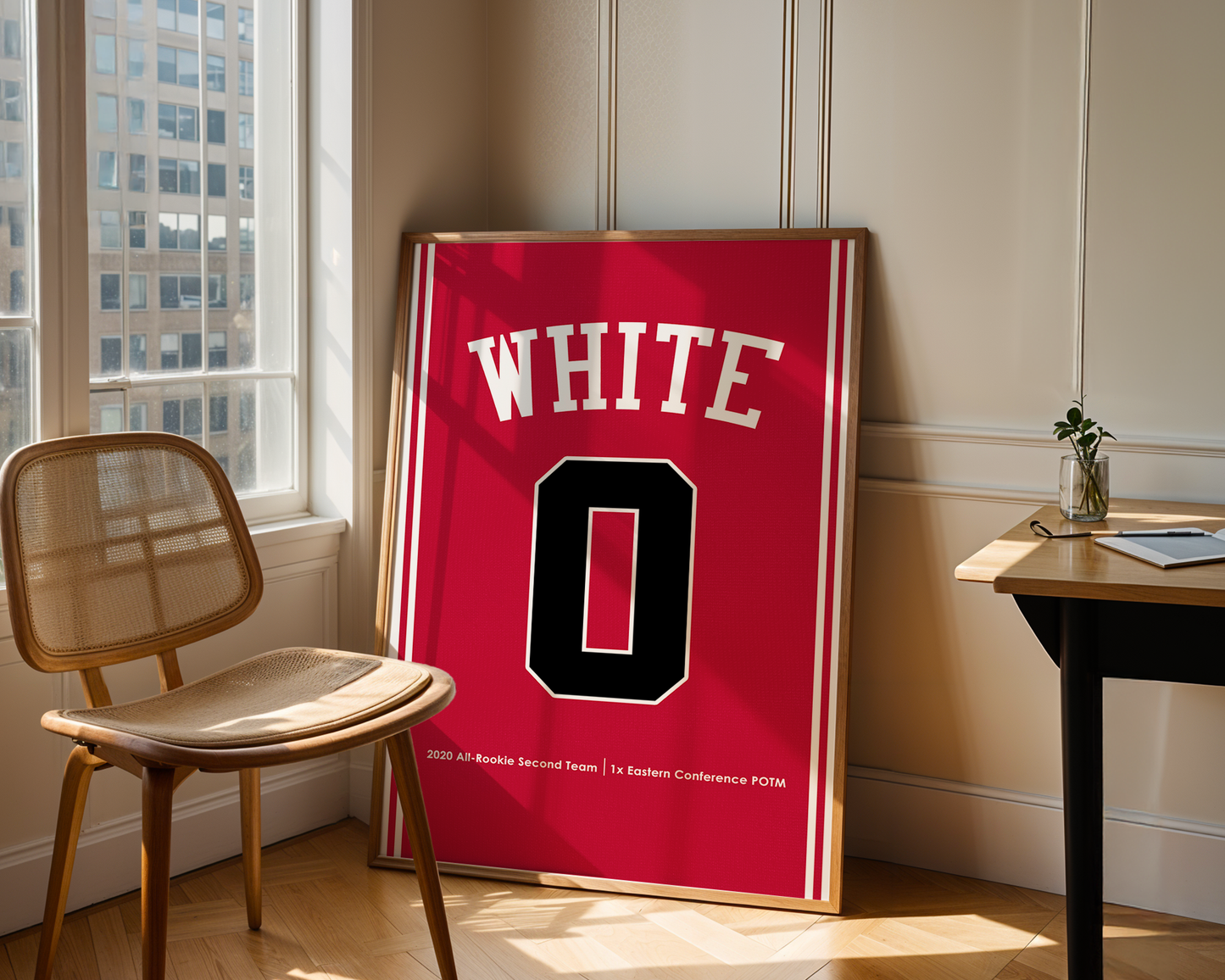 Red sports jersey with 'WHITE' and number '0' displayed in a room with a chair and table.