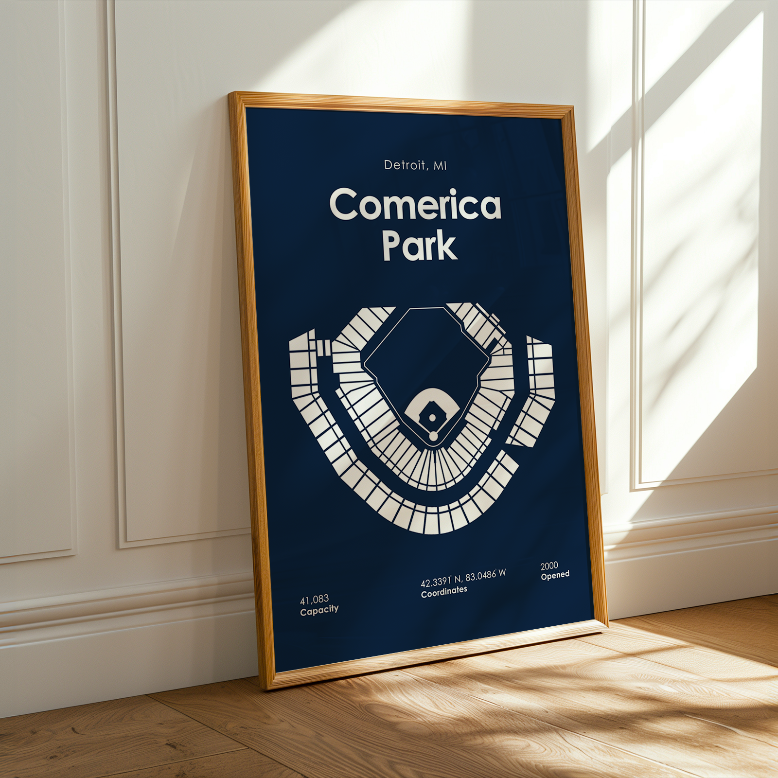 Framed poster of Comerica Park in Detroit, MI on a wall.