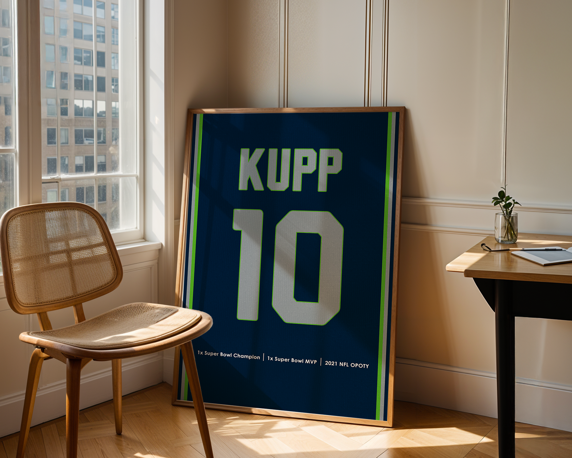 Framed sports jersey with 'KUPP 10' in a room with a window and chair.
