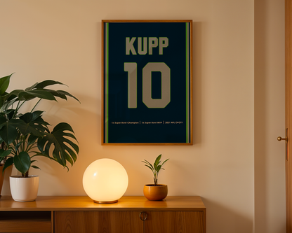 Framed poster with 'KUPP 10' on a wall above a wooden cabinet with decorative items.