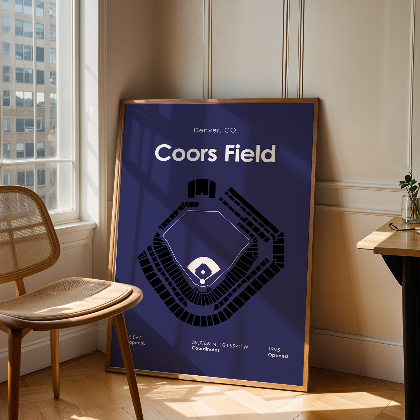 Framed Coors Field map poster in a room with a window and chair.