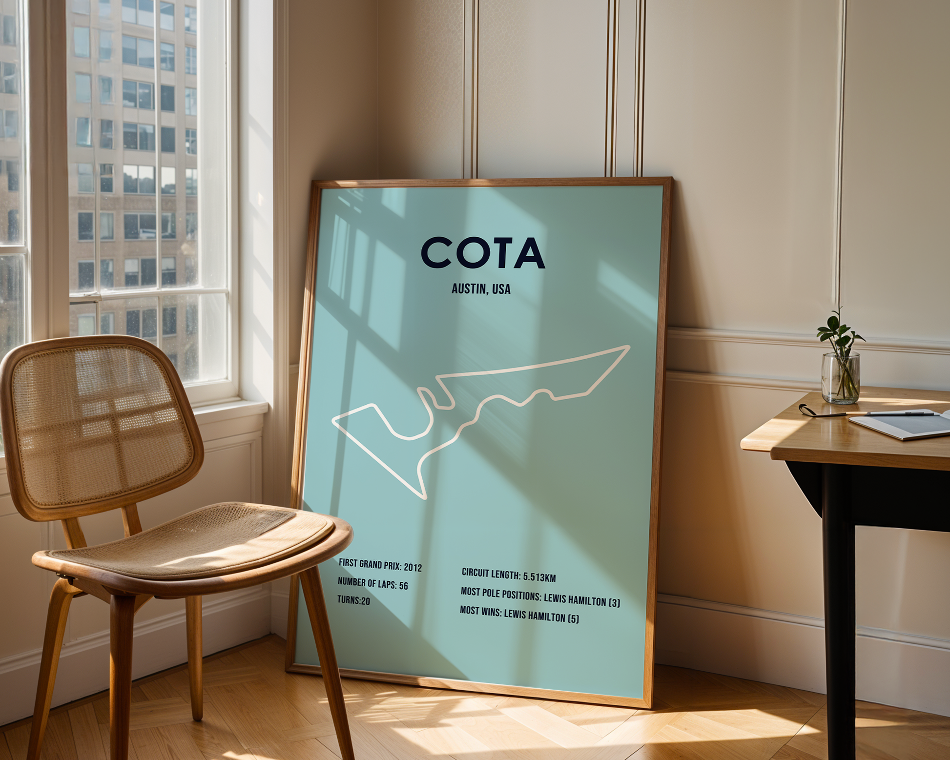 Framed poster with 'COTA Austin, USA' design in a room with a chair and table.