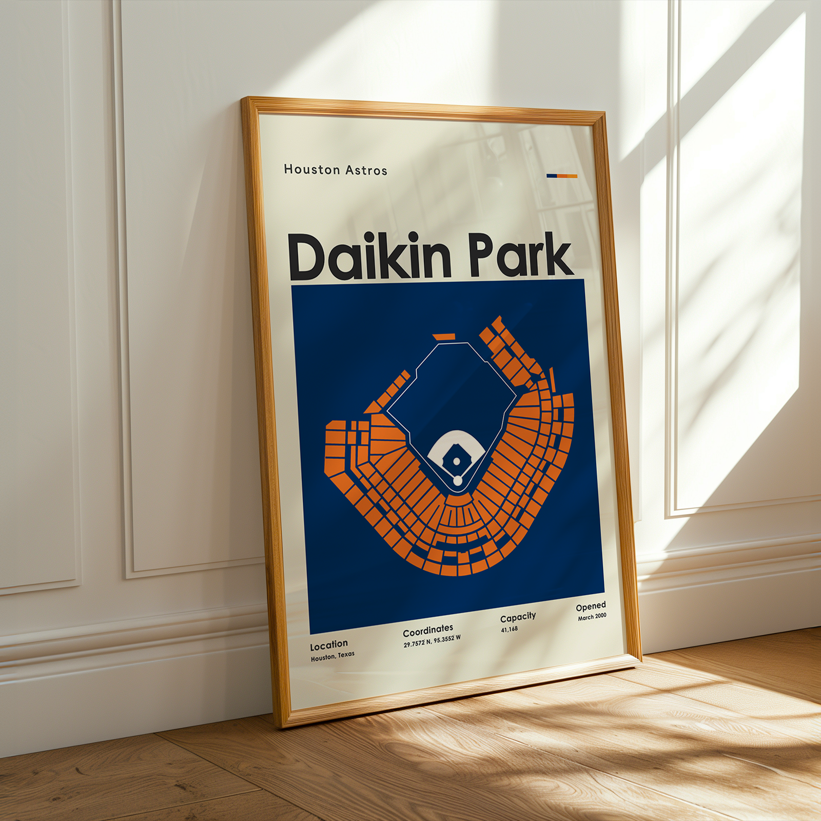 Framed poster of Daikin Park with Houston Astros branding on a wooden floor.