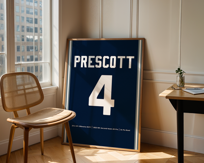 Framed sports jersey with 'Prescott' and number '4' in a room with a window and chair.