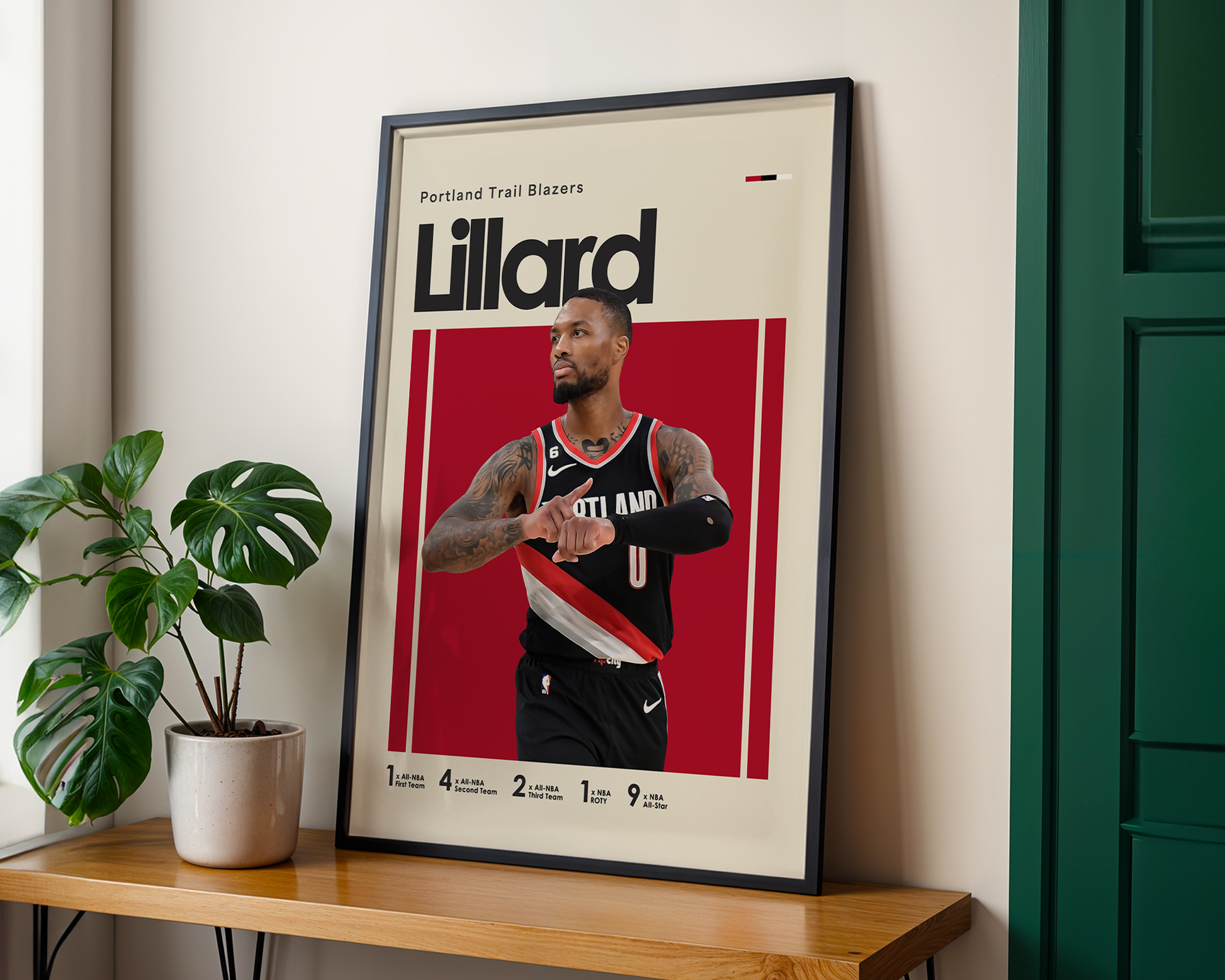 Framed poster of a basketball player with 'Lillard' on a wall next to a plant.