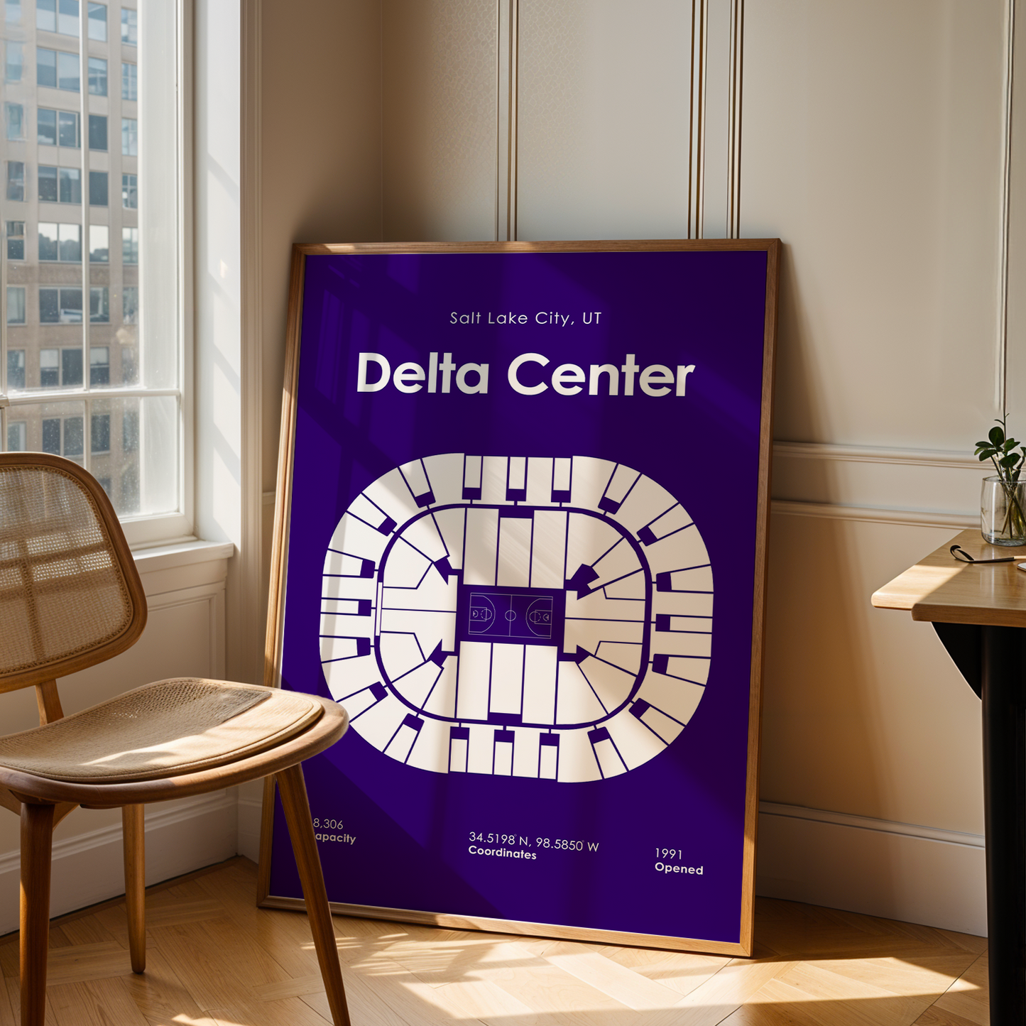 Poster of Delta Center in Salt Lake City, UT, leaning against a wall in a room with a chair and table.