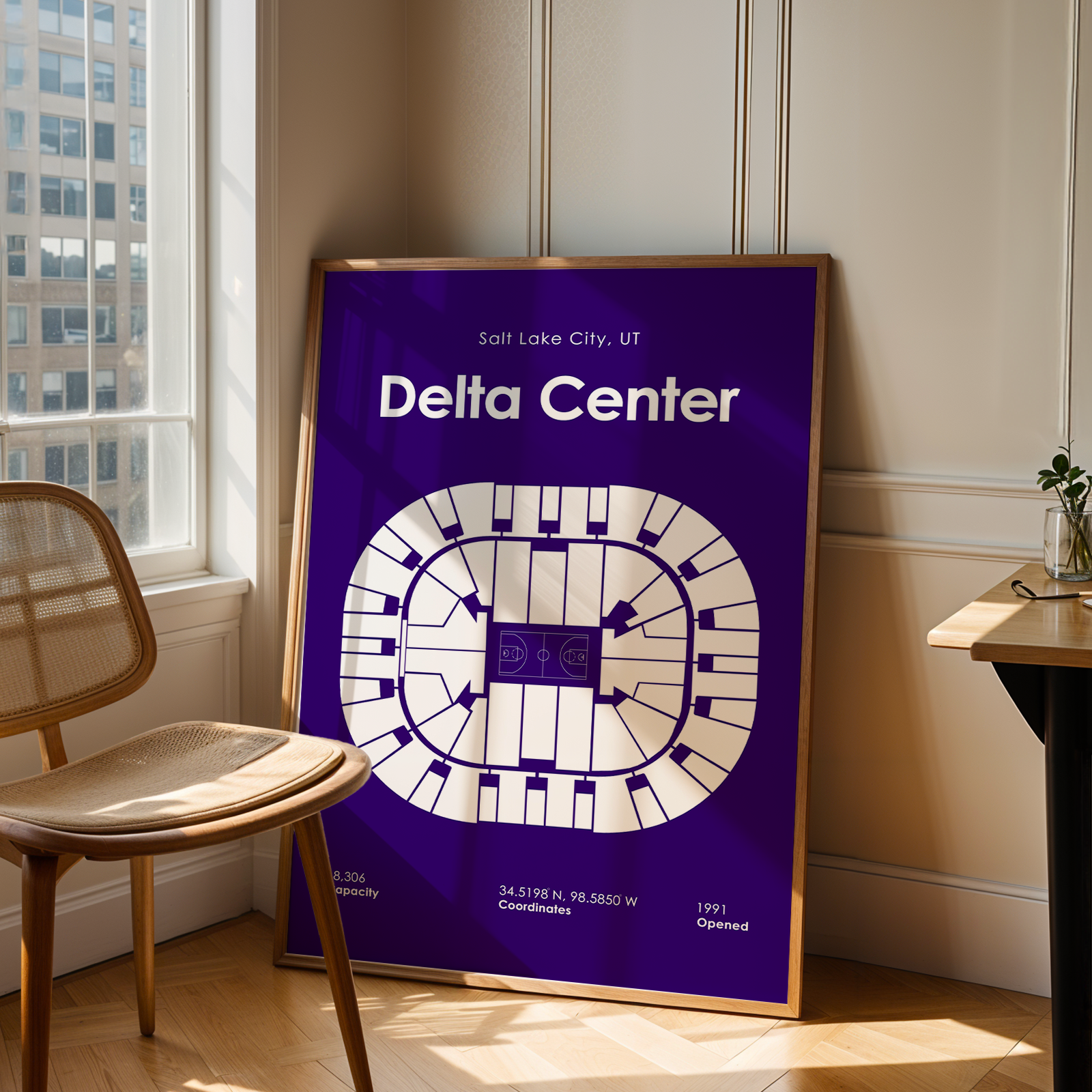 Poster of Delta Center in Salt Lake City, UT, leaning against a wall in a room with a chair and table.