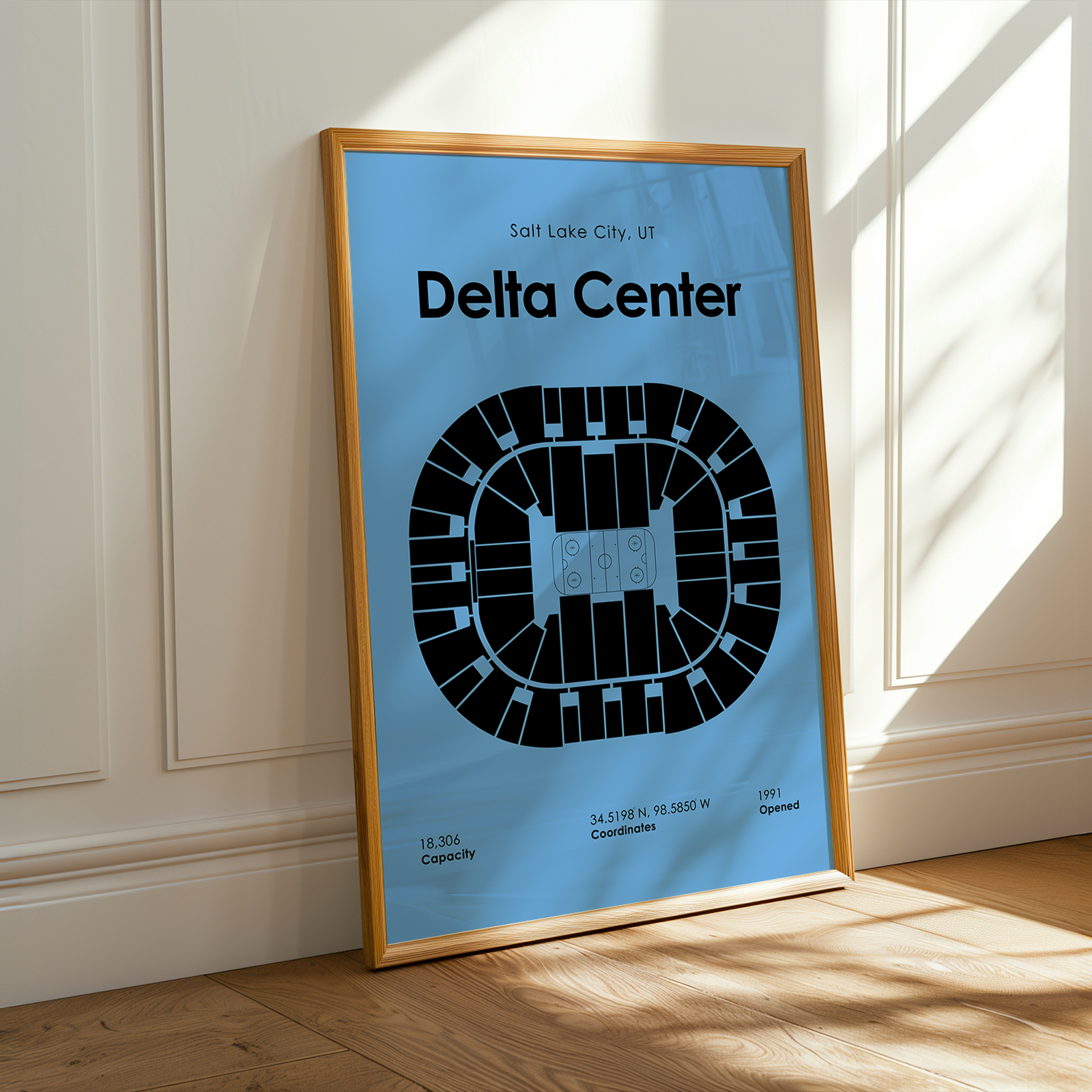 Framed poster of Delta Center layout on a wall with sunlight casting shadows.