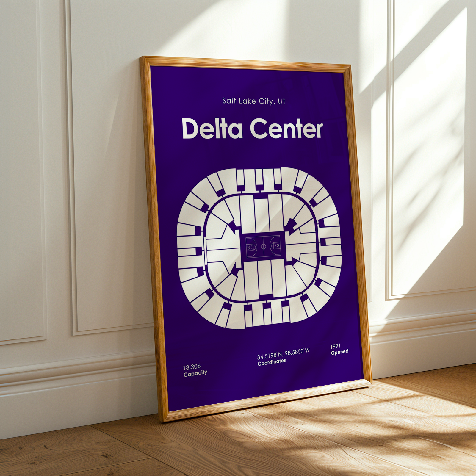 Framed poster of Delta Center layout on a wall with sunlight casting shadows.