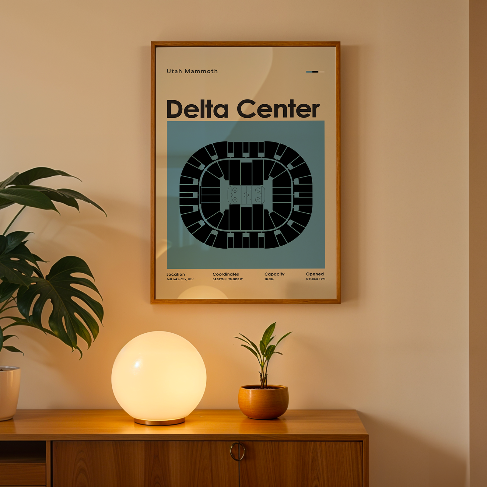 Framed poster titled 'Delta Center' on a wall above a wooden cabinet with decorative items.