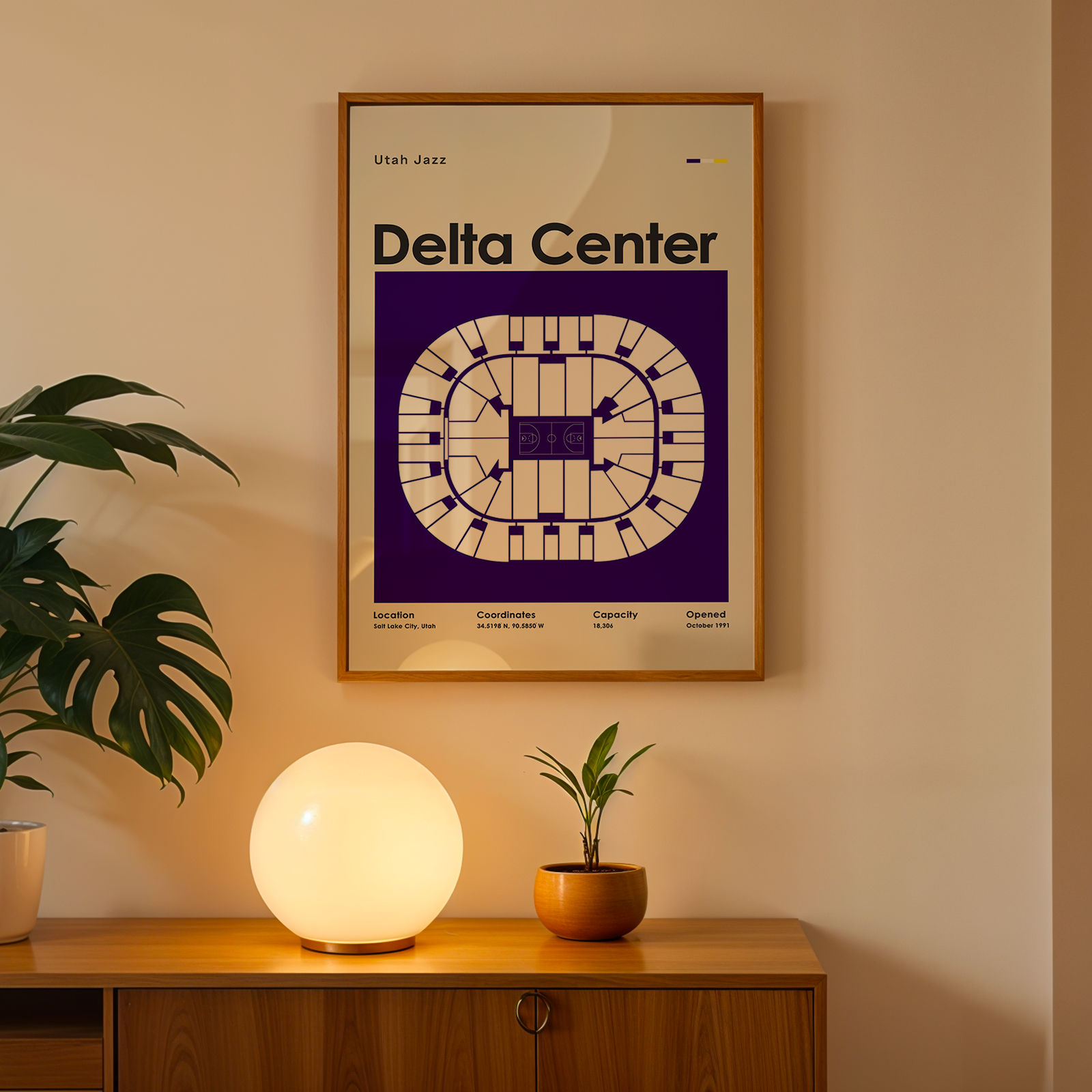 Framed poster with 'Delta Center' design on a wall above a wooden cabinet with decorative items.