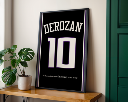 Framed poster with 'DEROZAN' and number '10' on a wooden table with a plant in the background