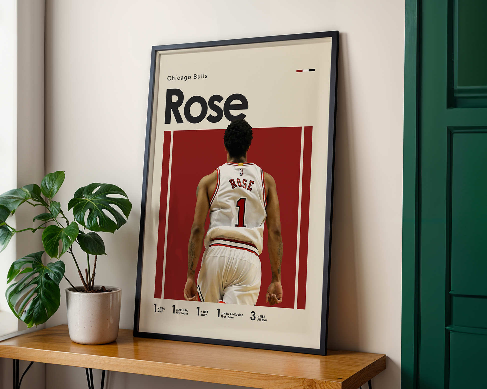 Framed poster of a basketball player with 'Rose' on a red background, placed on a wooden shelf.